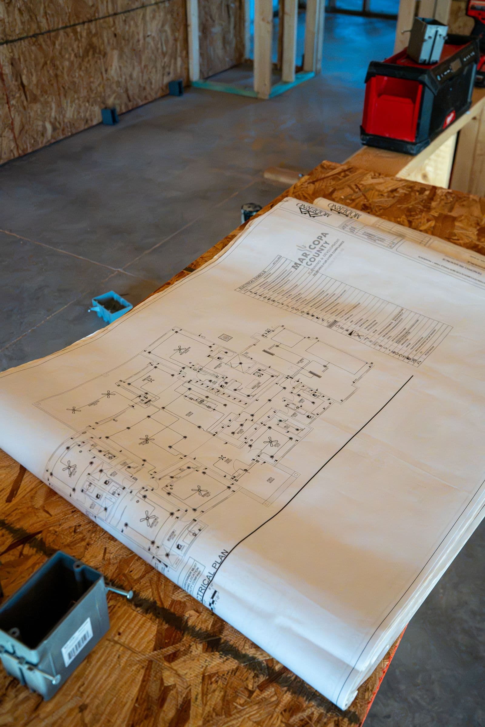 The electrical plan on plywood with a new box beside it